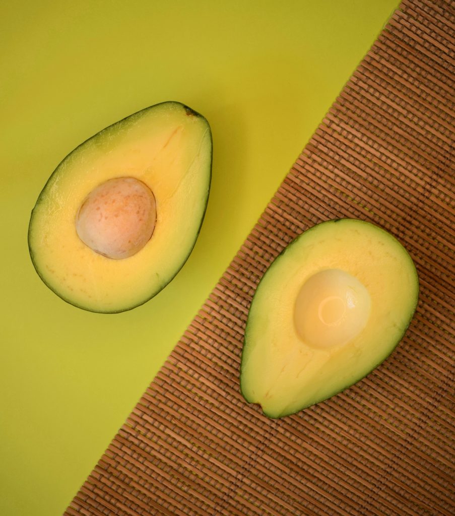 an avocado cut into two