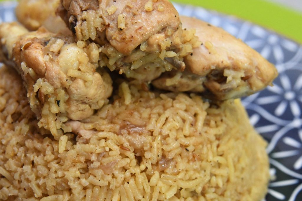 chicken pilau served on a blue and white plate